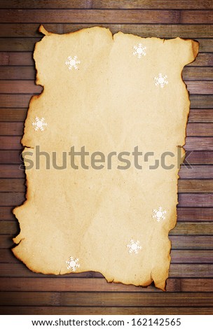 Old burnt empty paper  and decorative snowflakes,vertical
