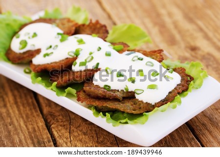 Potatoes pancakes with sour cream and chives