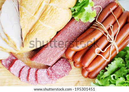 Still life of smoked chicken breast, sausage, sausages
