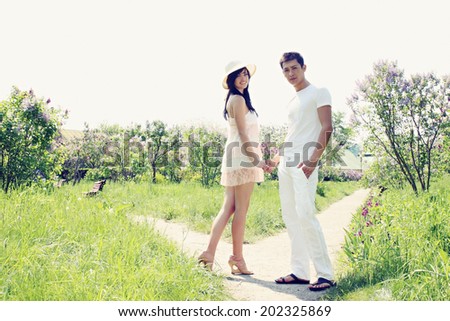 Young couple walking in the park holding hands