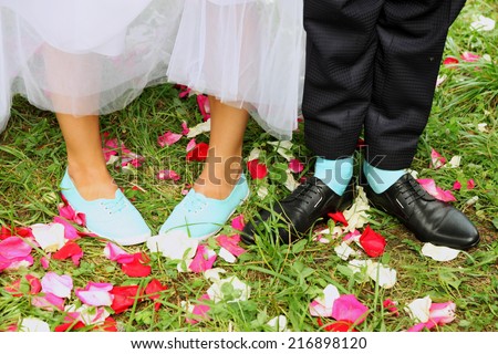 Legs bridal, groom wearing shoes, bride\'s moccasins