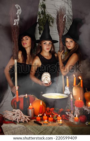three beautiful witch with a skull and brooms
