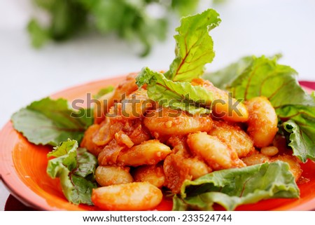 bean stew in tomato sauce with beetroot leaves