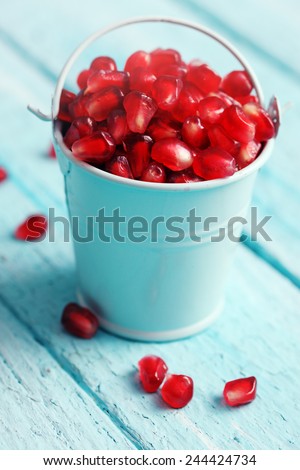 berry pomegranate in a small decorative bucket