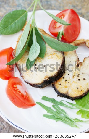 Grilled steaks grass carp with spices and herbs