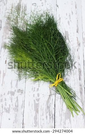 Fresh bundle of fennel on the wooden table