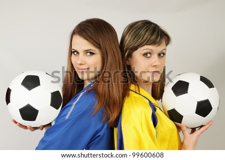 two beautiful football fans hold the balls