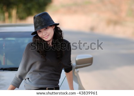 Pretty woman side by a car