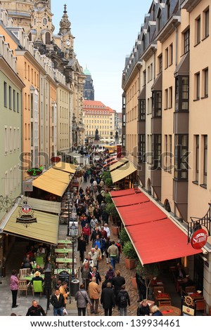 DRESDEN, GERMANY - MAY 1: People walk along Munzgasse May 1, 2013 in Dresden, Germany. Munzgasse - the street where there are many cafes and restaurants.