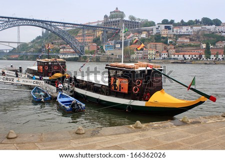 PORTO, PORTUGAL - MAY 6: Embankment Cais da Ribeira, May 6, 2013 in Porto, Portugal. At the waterfront moored small vintage ships for river cruise travel.