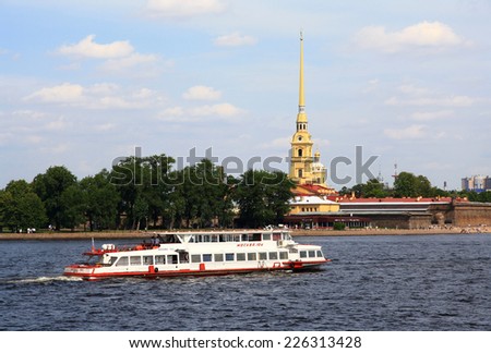 RUSSIA, SAINT - PETERSBURG - JULY 15, 2014 : Motor Ship goes along the Neva river near the Peter and Paul fortress - one of the symbols of the city.