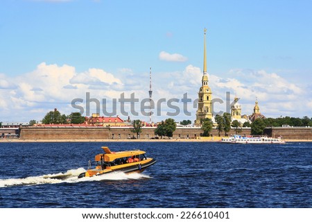 RUSSIA, SAINT - PETERSBURG - JULY 17, 2014 : Motor Ship goes along the Neva river near the Peter and Paul fortress - one of the symbols of the city.