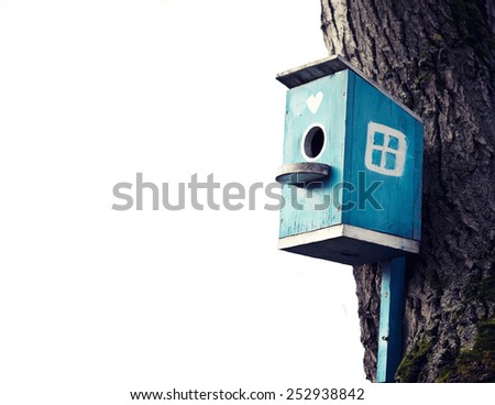 Old blue bird house isolated