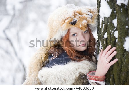 beautiful red hair woman in fox fur