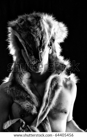 stock-photo-warrior-in-the-wolf-skin-low-key-studio-shot-64405456.jpg