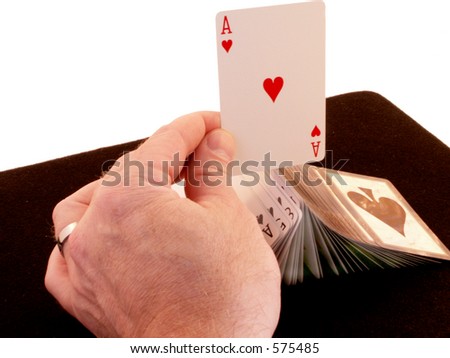 Ace sits on raised and fanned card deck, held with one hand as in display of dexterity by magician or gambler.
