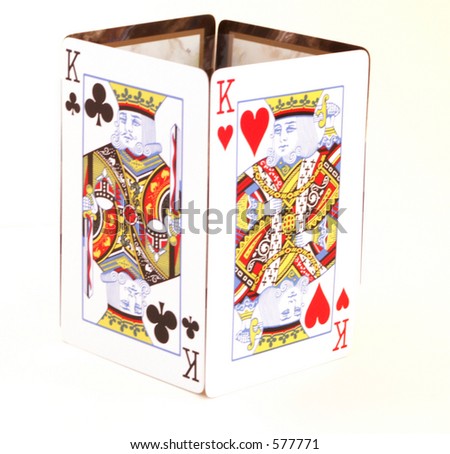 King of Clubs & King of Hearts stand up in cube on white table.
