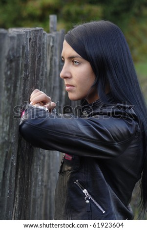 Portrait of beautiful woman near fence. More images of this models you can find in my portfolio