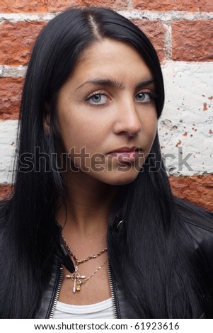 beautiful woman red bricks wall background. More images of this models you can find in my portfolio