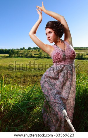Beautiful girl in dress on field clear blue sky end of summer russia