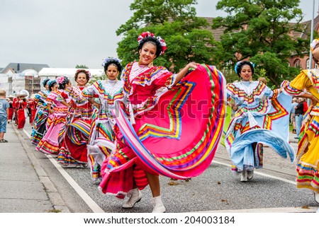 AABENRAA, DENMARK - JULY 6 - 2014: Mexican folk dancers in a parade at the annual tilting festival in Aabenraa