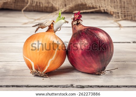 Red and white onions on a wooden table