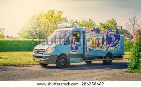 HORSENS, DENMARK - JUNE 11 - 2015: Blue icecream truck from Hjemis, driving around in a danish neighborhood