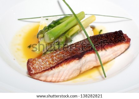 delightful baked fish with white rice and a green asparagus on a white plate, a diet, health