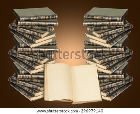 two vertical stack of books and an open book. Many books lie on each other