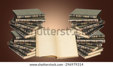Some ancient antiquarian books on a white background isolated. The open book with the yellow shabby pages near a pile of books. A shabby cover from skin with a gold stamping.