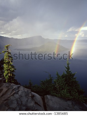 Wizard Island and a double rainbow, during a rain storm, in Oregonâ€™s Crater Lake National Park.