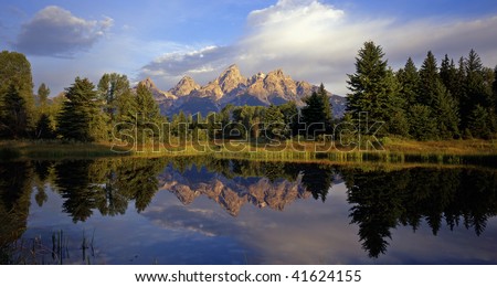 The Grand Teton Mountain Range reflecting in a beaver pond at Schwabackers Landing in Grand Teton National Park, located in Wyoming.
