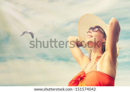 Relaxing Beach Woman Enjoying The Summer Sun Happy In A Wide Sun Hat At The Beach With Face Raised To The Sunlight.