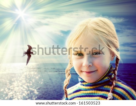 Portrait of the girl against the sea and the sun.