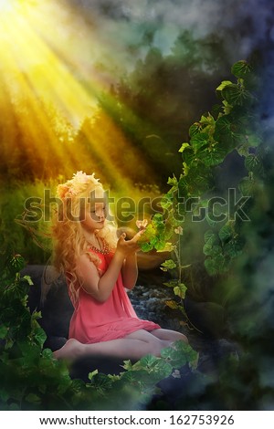 Sweet girl with butterfly wings in the fairy forest.