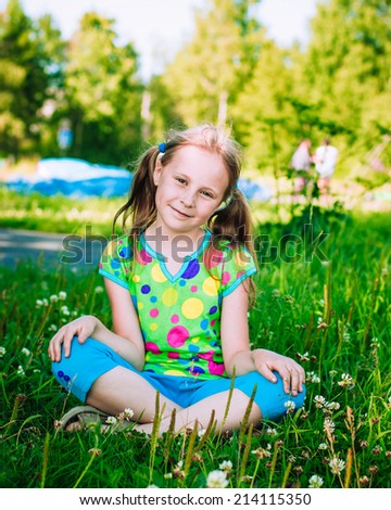 Beautiful girl in the meadow on a sunny summer afternoon.
