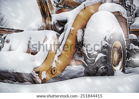 Wheel loader machine removing snow in winter on the road