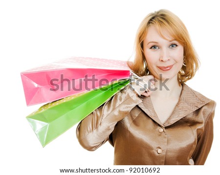A beautiful woman in a gold suit with shopping on a white background.