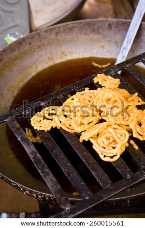 Freshly fried Jalebis dripping above the oil pan, Jaisalmer, India
