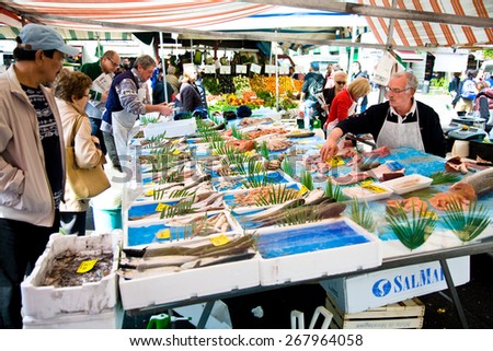Milan, Italy : 2014, April 5 : A fish market in the city of Milan in the Isola district with vendor and customers