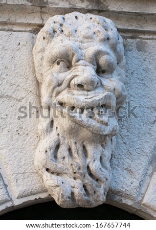 ugly man bas-relief stone face on Santa Maria Formosa Church facade, Venice, Italy