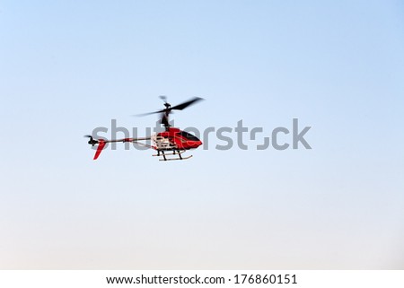 toy helicopter flying on blue sky background