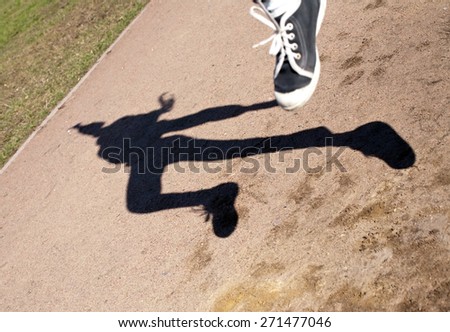 black figure silhouette of human shadow in flying jump