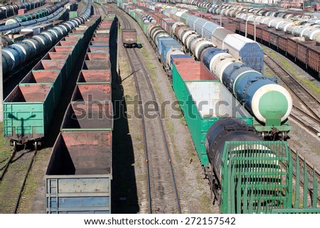 big railway cargo station junction with a lot of trains and track lines