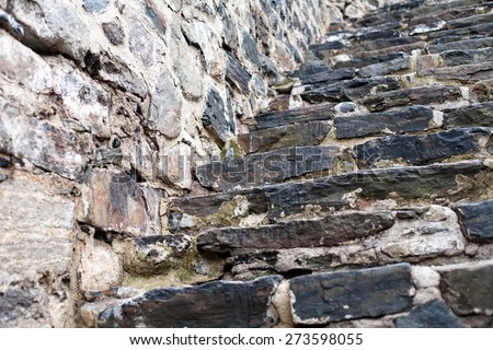 old fortress wall and staircase made from big stones masonry pattern background