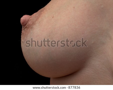 stock photo closeup of nude woman's breast on black background