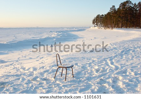 funny chair on coast of frozen sea; Finnish Bay of Baltic Sea, Russia