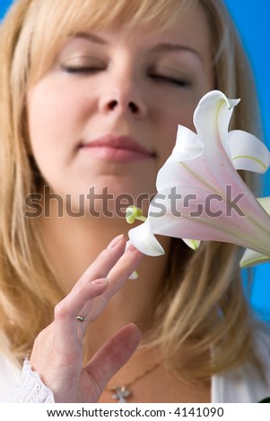 portrait of an young beautiful woman smelling madonna lily