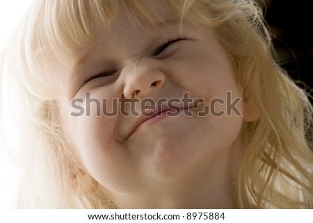 closeup of little beautiful girl making faces