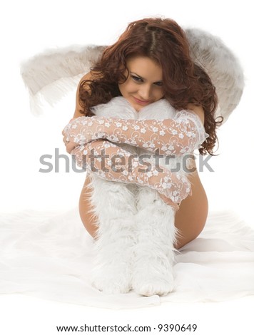 beautiful woman sitting in white dress and angel wings on the back isolated on white